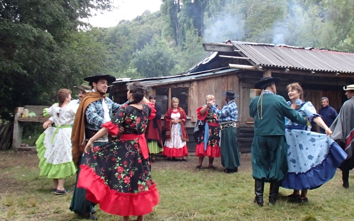 A group of people dance outdoors.